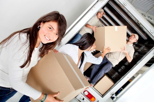 Professional movers handling furniture during a same day relocation