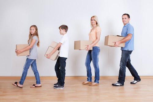 Team managing a moving job with safe handling procedures